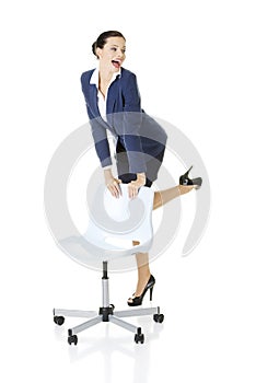 Businesswoman standing next to ofice chair