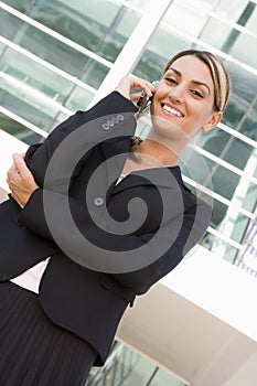 Businesswoman standing outdoors on cellular phone