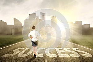 Businesswoman standing on the success way