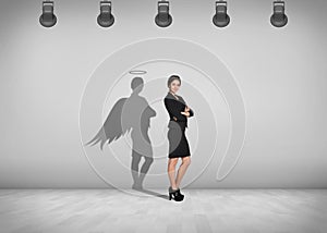 Businesswoman stands with shadow on the wall