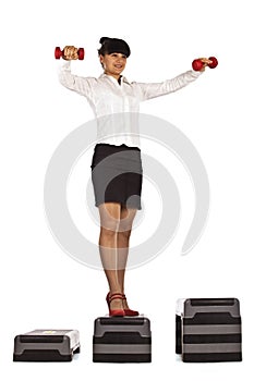 Businesswoman stands up with dumbbells