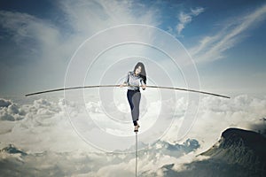 Businesswoman with a stick over mountains