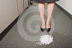 Businesswoman stood in front of pile of paper shreddings