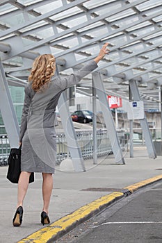 Businesswoman stopping a taxi