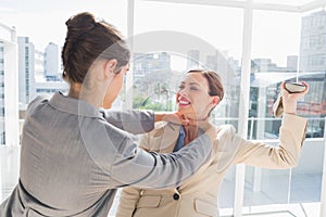 Businesswoman strangling her partner photo