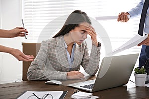 Businesswoman stressing out at workplace in office photo