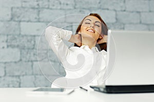 Businesswoman stretching in front of her workplace