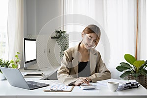 Businesswoman in stylish dress working in modern office.