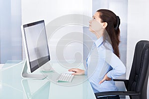 Businesswoman suffering from back pain
