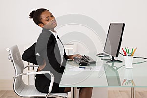 Businesswoman Suffering From Backache In Office