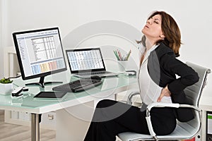 Businesswoman Suffering From Backache In Office