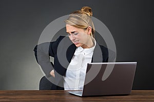 Businesswoman Suffering From Backpain While Using Laptop photo