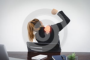 Businesswoman suffering from shoulder pain at work injury or illness that may occur with sitting at work pain, pain or discomfort photo