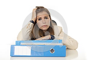 Businesswoman suffering stress and headache at office desk looking worried depressed and overwhelmed