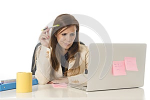 Businesswoman suffering stress at office computer desk looking worried depressed and overwhelmed