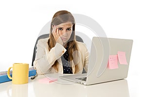 Businesswoman suffering stress at office computer desk looking worried depressed and overwhelmed