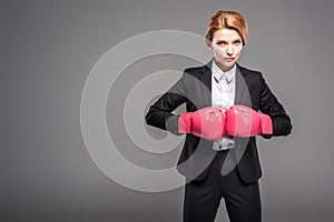 businesswoman in suit and formal wear and pink boxing gloves