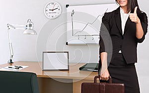 Businesswoman in suit holding briefcase and