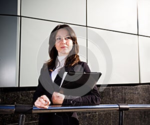 Businesswoman in suit holding papers in hands