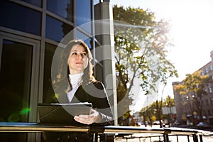 Businesswoman in suit holding papers in hands