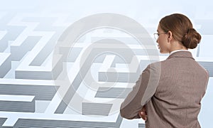 Businesswoman in suit looking for way out of maze