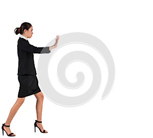 Businesswoman in suit standing and pushing