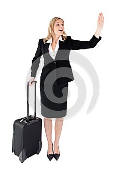Businesswoman with a suitcase calling a taxi