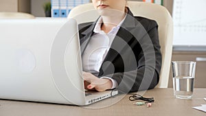 Businesswoman in suits plugging the audio and microphone cords in the laptop