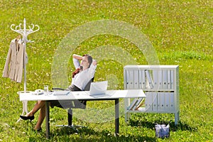 Businesswoman in sunny meadow relax nature office