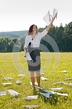 Businesswoman sunny meadow throw papers freedom