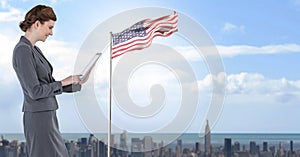 businesswoman on tablet with american flag in cityscape