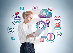 Businesswoman with tablet and network data icons on background