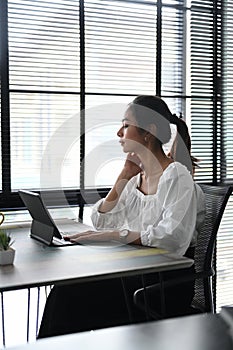 A businesswoman is take a break relaxing and closed eyes .