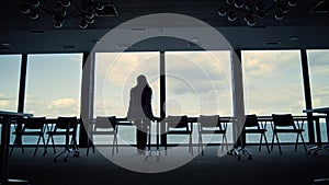 Businesswoman taking break looking window. Beautiful tranquil sea view in office