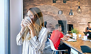 Businesswoman taking a coffee break in the office