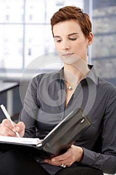 Businesswoman taking notes