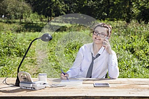 Businesswoman taking notes while talking