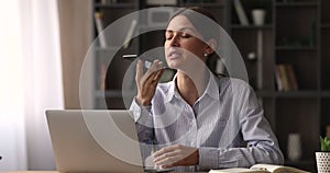 Businesswoman talk to client distantly using smartphone and speakerphone