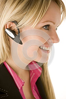 Businesswoman Talking On Hands Free Phone