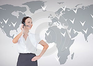 Businesswoman talking on headset with world map in background