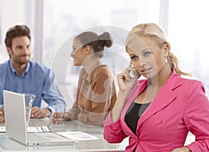 Businesswoman talking on mobile at meeting