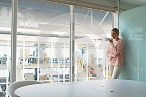 Businesswoman talking on mobile phone in the conference room at office