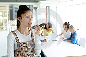 Businesswoman talking on mobile phone in a modern office