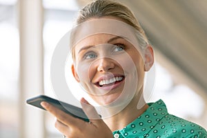 Businesswoman talking on mobile phone in office