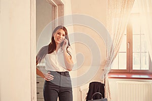 Businesswoman talking on the phone in hotel room
