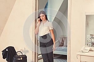 Businesswoman talking on the phone in hotel room