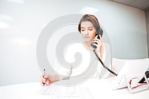 Businesswoman talking on the phone in office