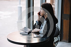 businesswoman talking on the phone and taking notes