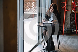 businesswoman talking on the phone and taking notes