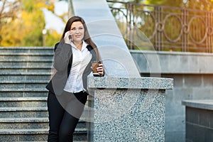 Businesswoman talking on phone while walking outdoor